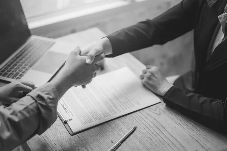 Client meets with an attorney shaking hands
